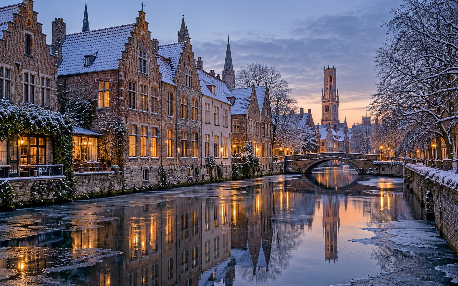 Stepped gable houses reflected in a frozen Bruges canal