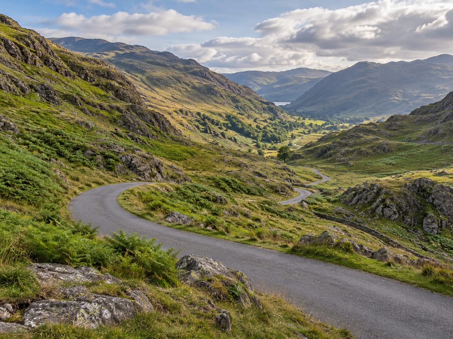 A narrow road winding over a high mountain pass